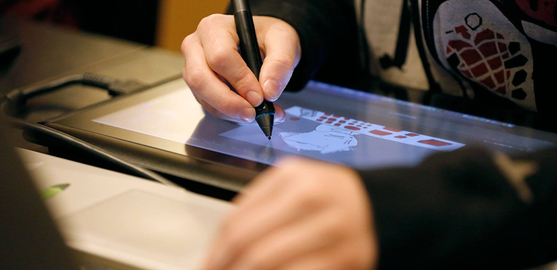 A photo of a student working at a tablet.