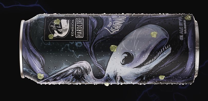 An image of a kombucha can with a purple whale on it.