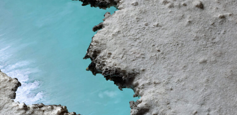 A photograph of a closeup of land and water.