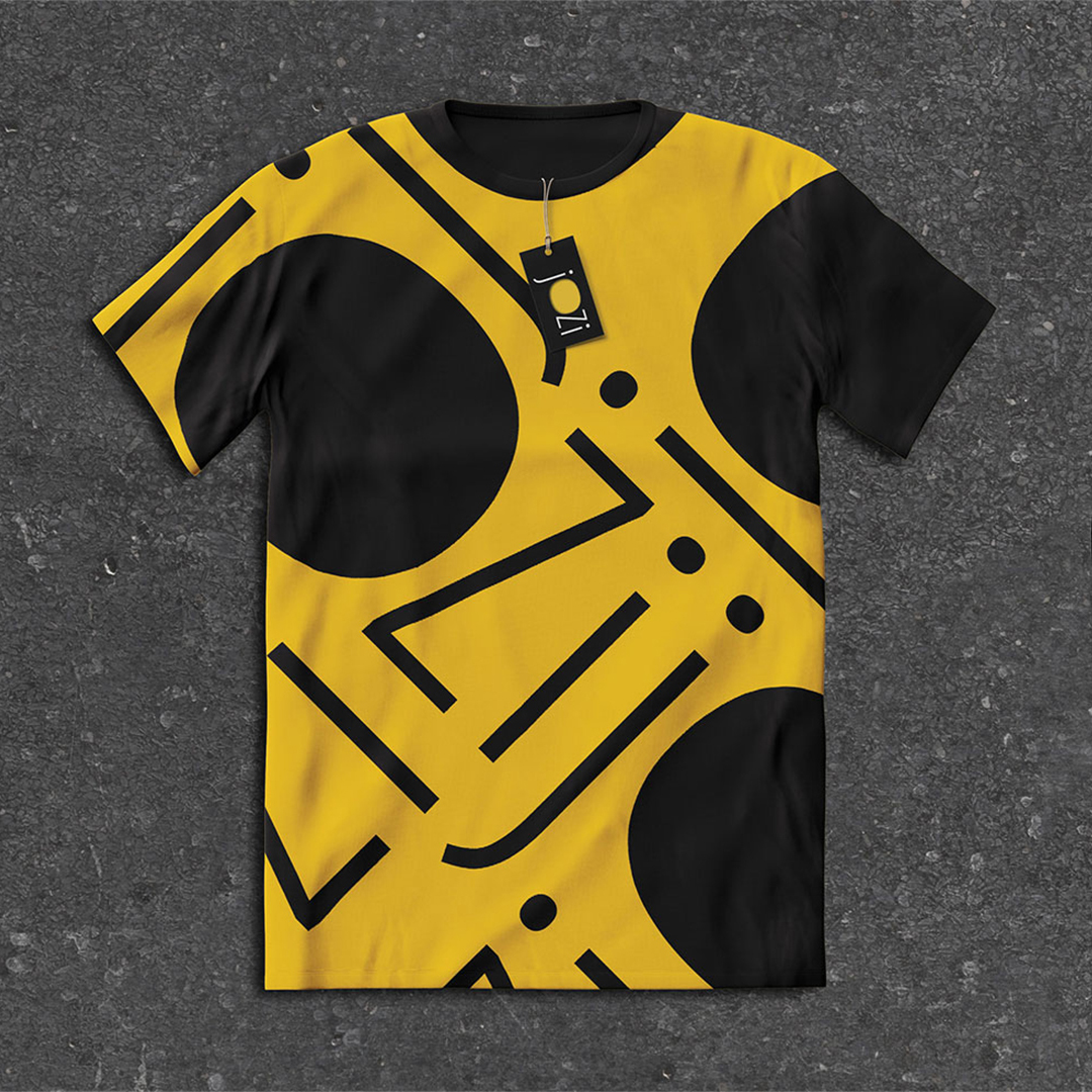 A photograph of a black and yellow shirt and tote bag, with the word "jozi"