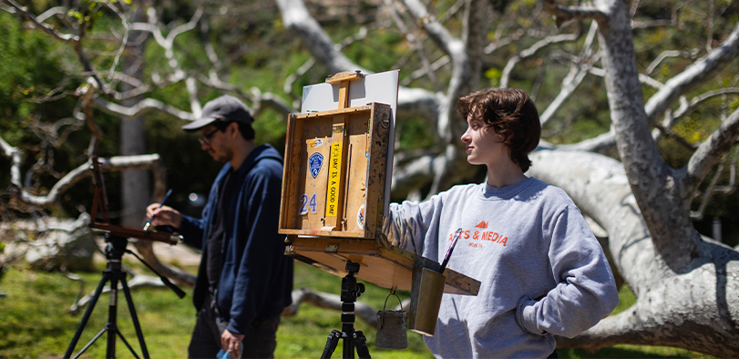 A photo of students painting in Nina's Park.