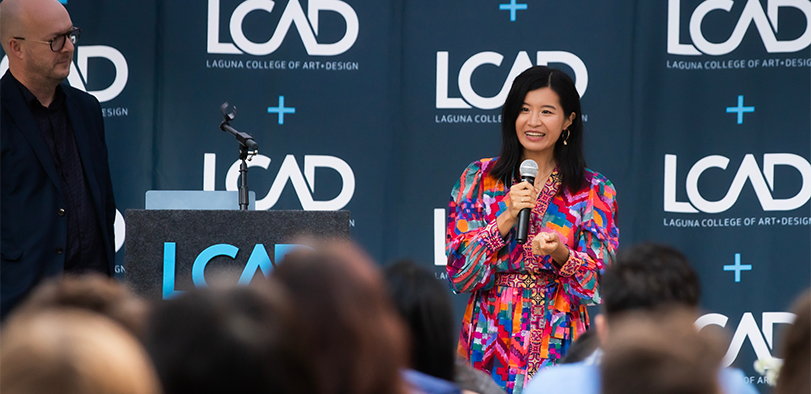 A photo of a faculty member presenting at Commencement.