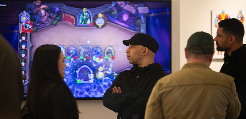 A photo of guests watching a game presentation.
