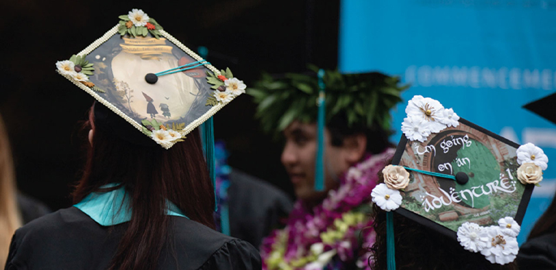 A photo of two students in their caps and gowns.