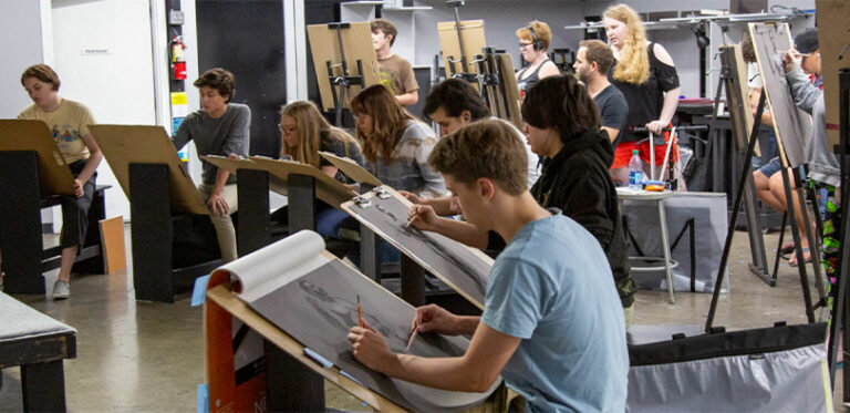 A photo of students sketching at easels.