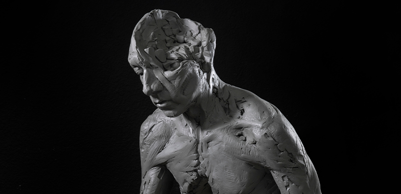 A photo of a sculpture of a man's had and torso.