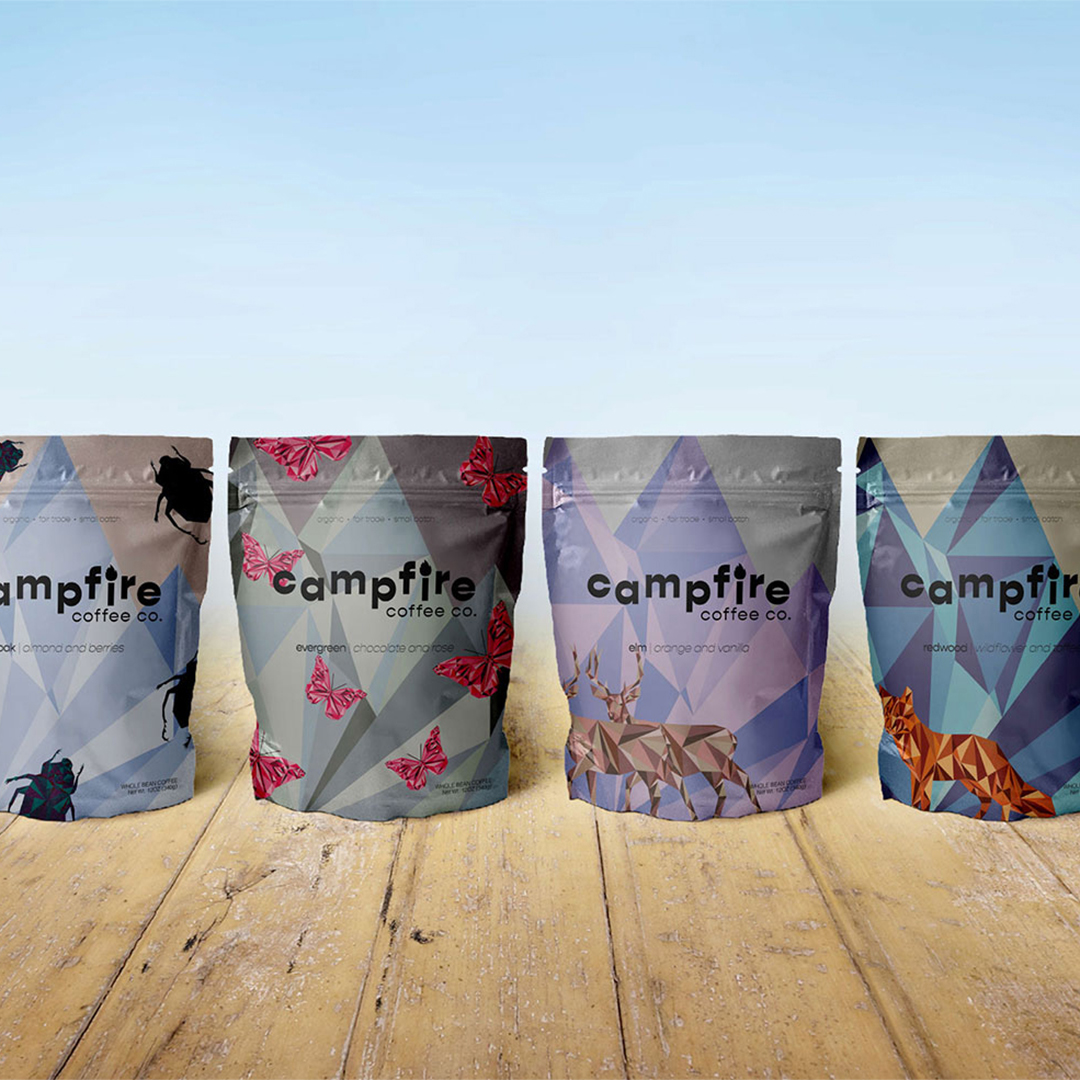 A photo of six bags of coffee lined up. they are all different colors.