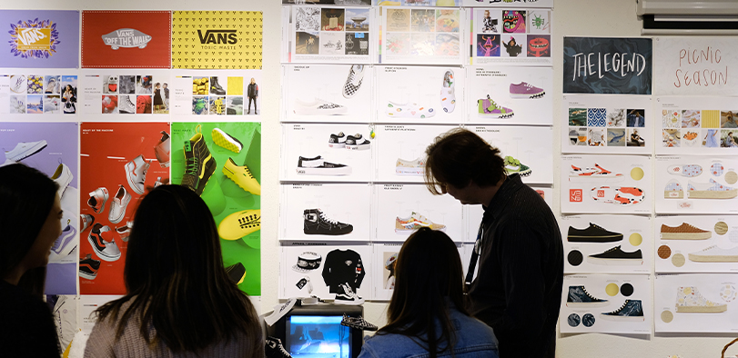 A photo of an instructor and students in a classroom.