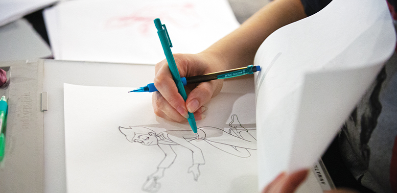 A photo of a person's hand sketching.