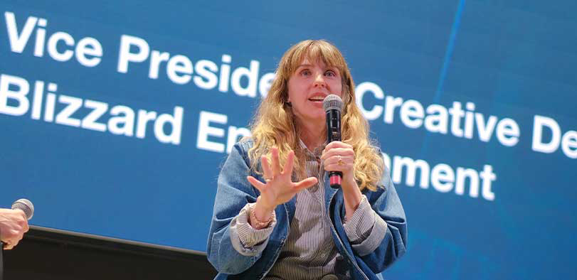 A photo of Scoggins giving a talk on the Rivian stage.