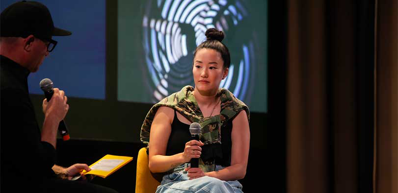 A photo of Chang giving a talk on the Rivian stage.