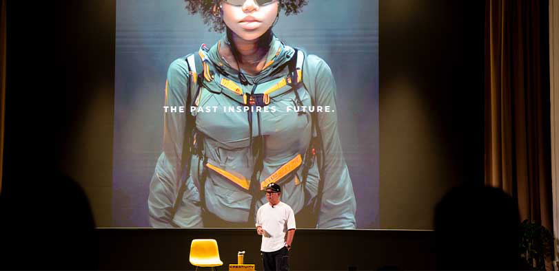 A photo of Takumi giving a talk on the Rivian stage.