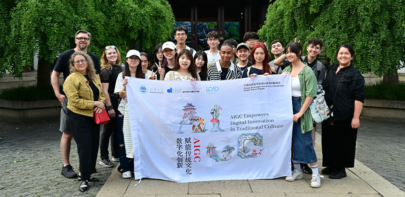 A photo os students posing with a banner.