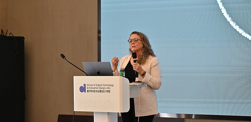 A photo of Dana Herkelrath giving a presentation.