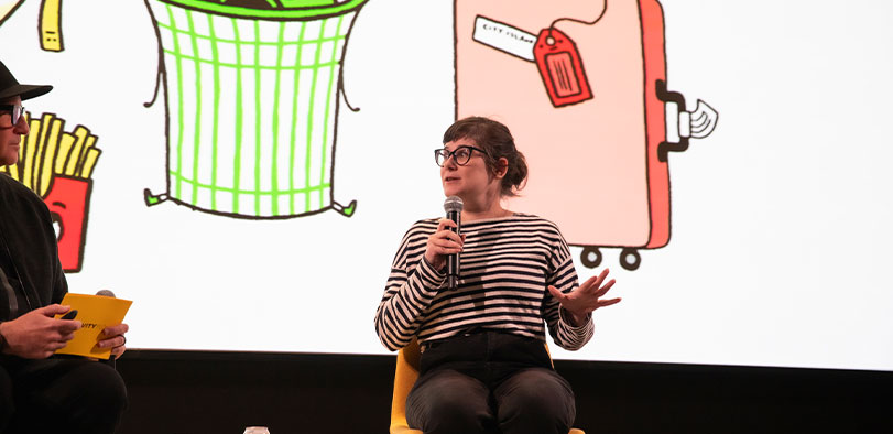 A photo of Gemma Correll presenting at the Rivian Theater.