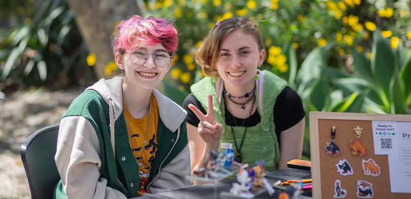 A photo of two students posing at art market.