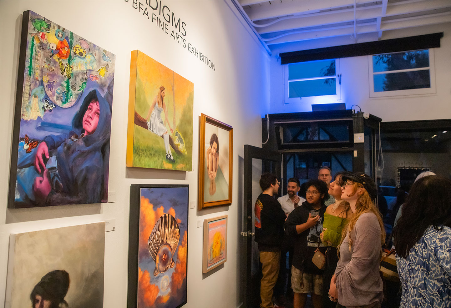 A photo of people at the BFA graduate exhibition in the LCAD Gallery.