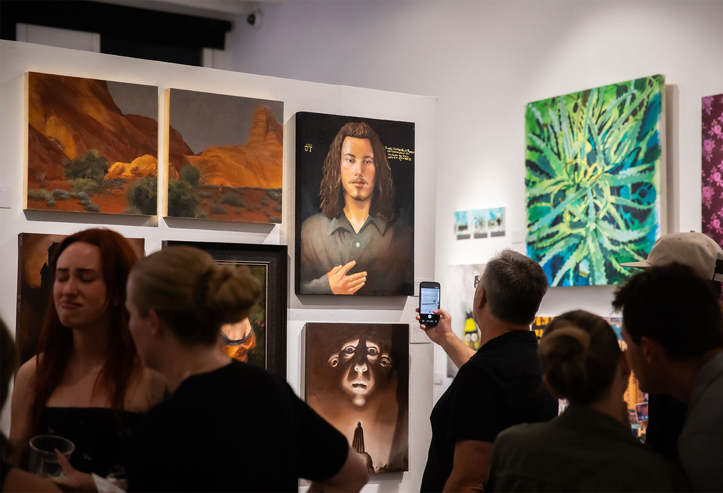 A photo of people at the BFA graduate exhibition in the LCAD Gallery.