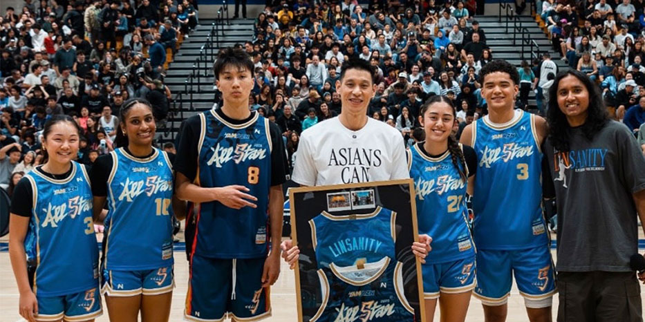 A photo of Brandon Tam standing with athletes wearing his uniform designs.