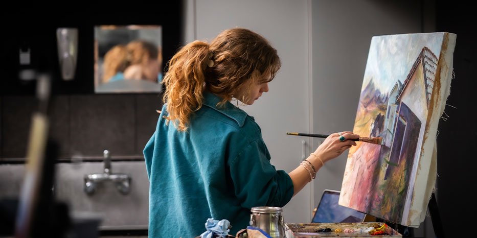 A photo of a student painting.